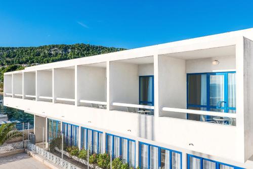 a white building with a view of the water at Hotel Jadran in Split