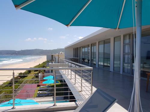a balcony with a view of the beach and the ocean at MGM Wilderness in Wilderness