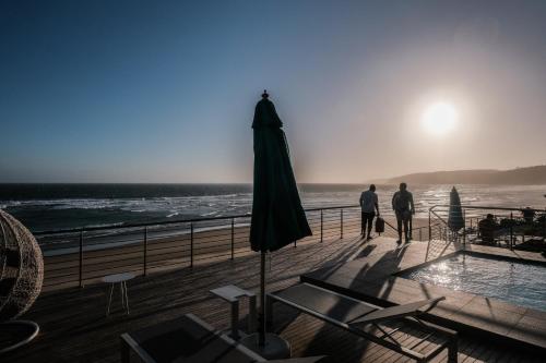 two people standing on a deck looking at the ocean at MGM Wilderness in Wilderness