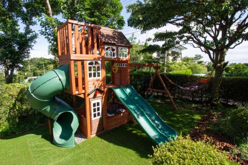 a playground with a slide and a play house at KandoStay 伊豆高原パークガーデン in Ito