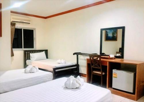a hotel room with two beds and a desk and a computer at Golden Bee PhiPhi in Phi Phi Don
