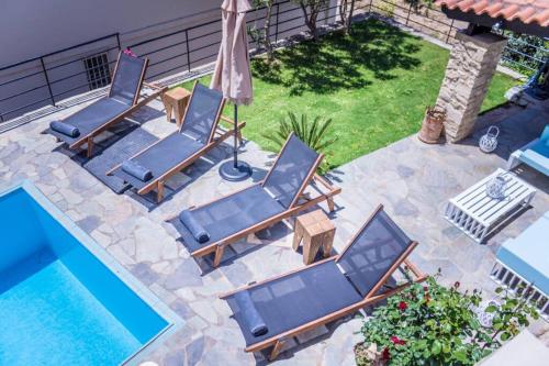 una vista sul soffitto delle sedie a sdraio e sulla piscina di Villa Ventus, 40sqm private pool & hot tub! a Roussospítion