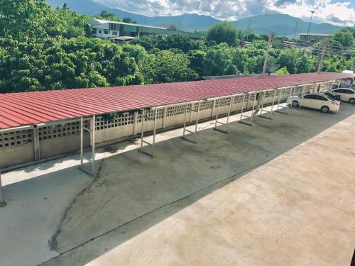 a train station with cars parked in a parking lot at Smile Place (สมายเพลส) in Chiang Mai