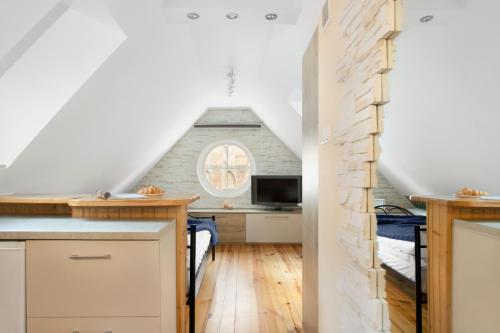 a kitchen with a staircase leading to a loft at Elite Apartments Rooftop with a View of the Old Town in Gdańsk
