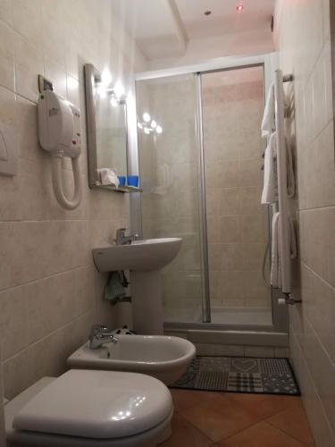 a bathroom with a toilet and a sink and a shower at affittacamere la loggia in Levanto