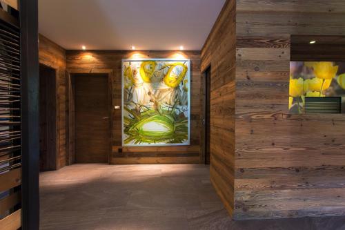 a hallway with a painting on the wall at Aparthotel Tyrol in Lermoos