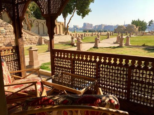 a chair sitting next to a fence in a cemetery at Djorff Palace in Luxor