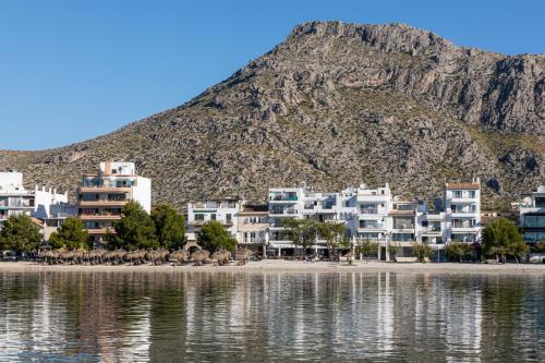 a group of houses on the shore of a body of water at Hoposa Bahia in Port de Pollensa
