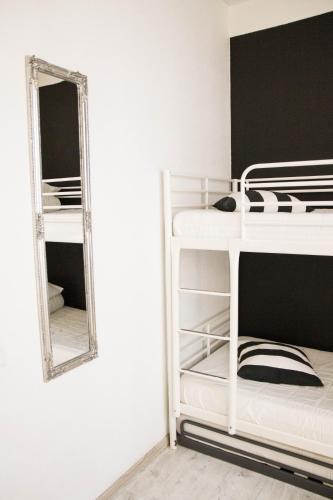 a bedroom with bunk beds and a mirror at Amber Private Rooms in Rīga