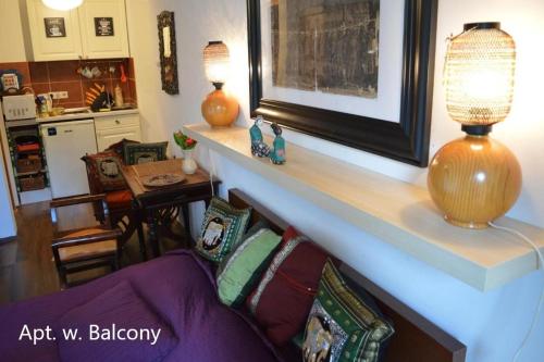 a living room with a couch with pillows on it at Cozy studio at the Castle in Budapest