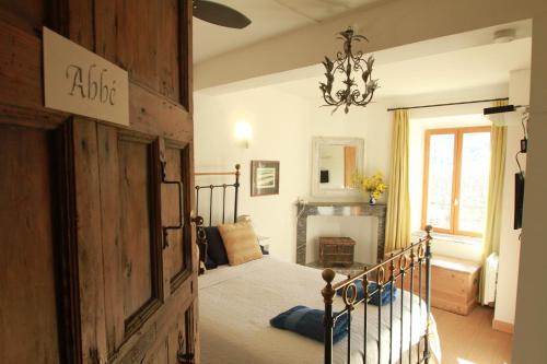 a bedroom with a bed and a chandelier at Mas St. Joseph in Ille-sur-Têt