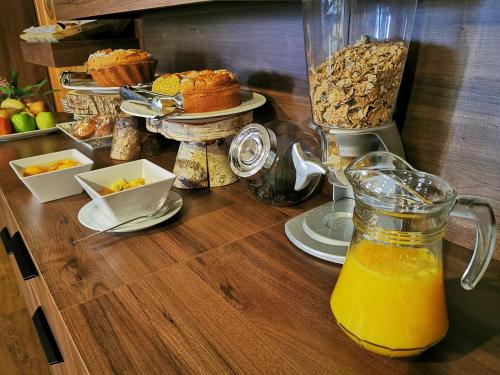 Una mesa sobre la que hay una licuadora llena de jugo de naranja. en Hotel Pensua Punta del Este, en Carballo