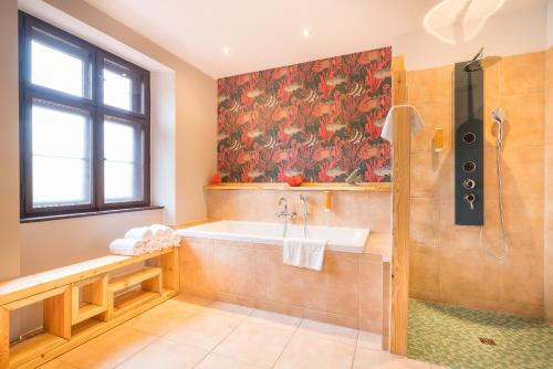 a bathroom with a tub and a sink and a shower at Design Apartments - "Heiliger See" in Potsdam