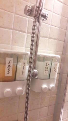 a bathroom with a shower with shelves in it at Katane337 in Catania