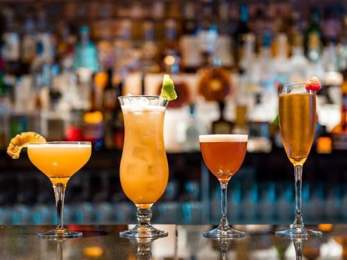 a group of four cocktails sitting on a bar at Dakota Edinburgh in Queensferry