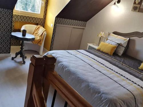 a bedroom with a large bed and a table at Bulle de sel in Caudan