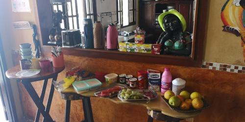 a counter with a table with food and a mirror at Pousada Favelinha in Rio de Janeiro