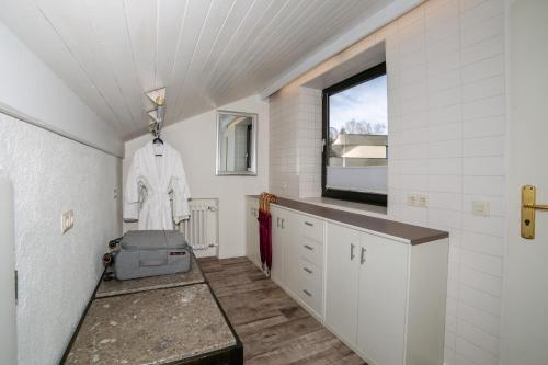 a bathroom with white walls and a window at Hotel Brandl in Bad Wörishofen