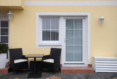 a table and chairs in front of a window at Villa Katharina in Rust