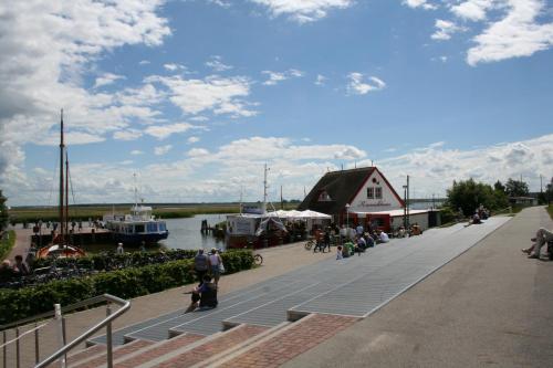 a group of people sitting on a dock next to a marina at Hotel Boddenhus Garni in Zingst