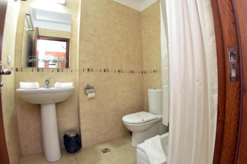 a bathroom with a sink and a toilet at Hotel Miorita Neptun in Neptun