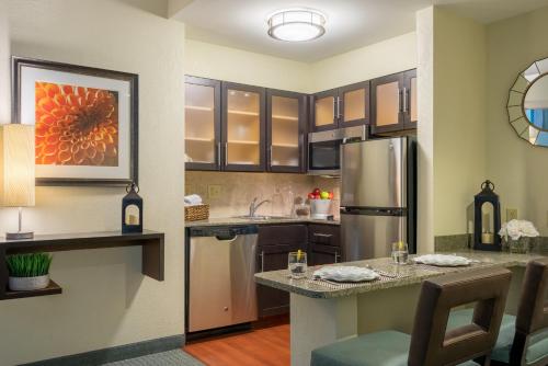 a kitchen with a stainless steel refrigerator and cabinets at Staybridge Suites Wilmington - Brandywine Valley by IHG in Glen Mills