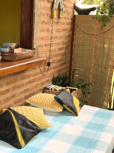 a bed with two pillows on it in a room at Pousada kaz'oca in Icaraí