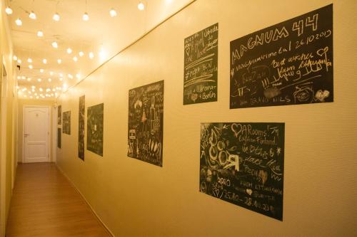 a hallway with posters on the walls of a building at Amber Private Rooms in Rīga