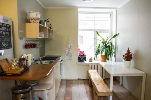 a kitchen with a table and a bench in it at Amber Private Rooms in Rīga