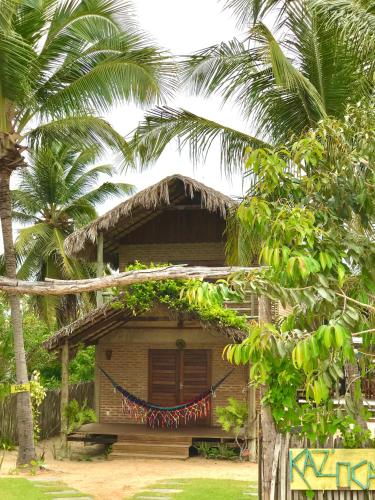 a house with a hammock in front of it at Pousada kaz'oca in Icaraí