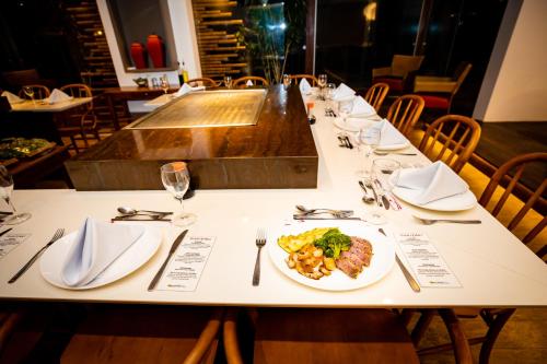 a table in a restaurant with a plate of food at Ocean Palace All Inclusive Premium in Natal