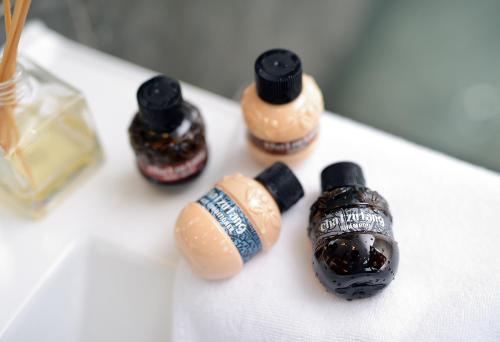 a group of three different types of bottles on a table at Yunoyado Onsen Hot Spring Hotel Deyang in Jiaoxi