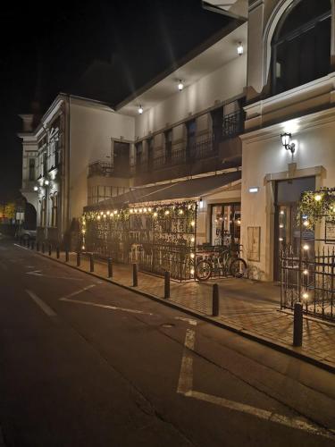 an empty street at night with a building at Apartament The Bricks 1903 in Bistriţa