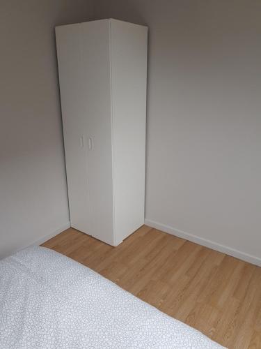 an empty room with white doors and a wooden floor at Central Yellow Apartment in Brussels
