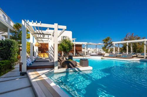 a swimming pool with blue water in a building at Semeli Hotel Mykonos in Mikonos