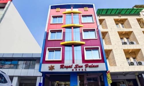 a tall pink building with a sign on it at Treebo Trend Royal Sun Palace MP Nagar Zone 2 in Bhopal