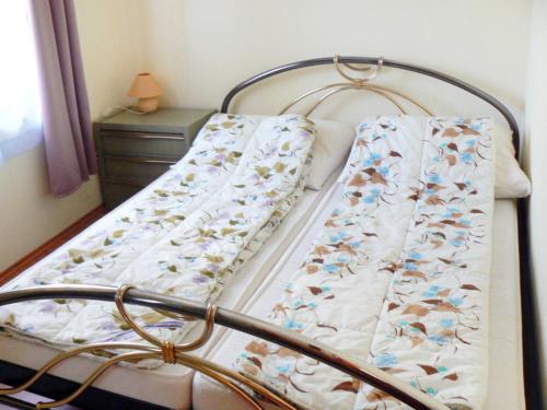 a bed with a blanket on it in a bedroom at Tamás Ház in Balatonőszöd