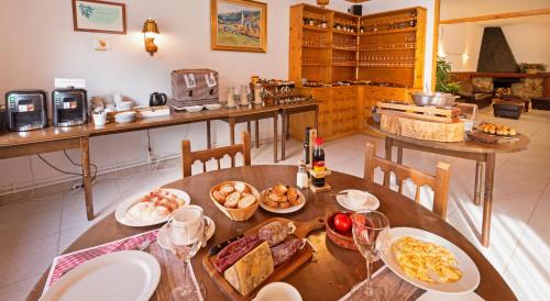 a kitchen with a table with food on it at Hostal Trainera in Esterri d'Àneu