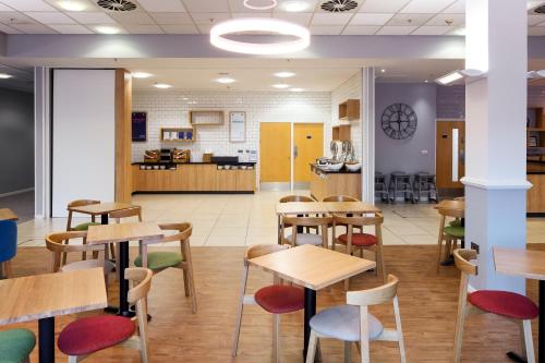 a classroom with tables and chairs in a cafeteria at Holiday Inn Express Hull City Centre by IHG in Hull