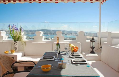 a table with a bottle of wine on a balcony at Dar Chams Tanja in Tangier