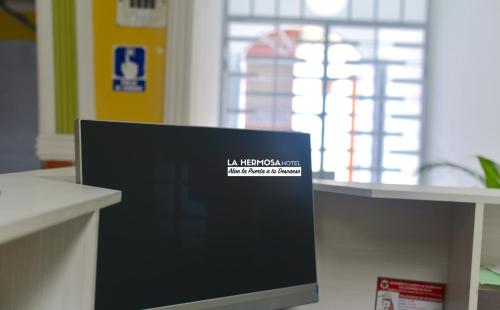 a computer monitor sitting on a counter in a room at La Hermosa Hotel in Buga
