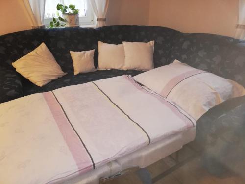 a black couch with pillows on top of it at Ferienhaus Schlossblick in Landl