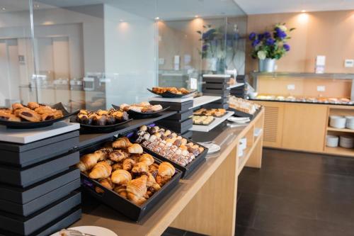 a buffet line with many different types of pastries at Atenea Port Barcelona Mataró in Mataró