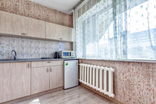 a kitchen with a white refrigerator and a window at 430 Апартаменты в Золотом квадрате в центре Отличный вариант для туристов и командированных in Almaty