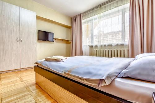a bedroom with a large bed with a window at 430 Апартаменты в Золотом квадрате в центре Отличный вариант для туристов и командированных in Almaty