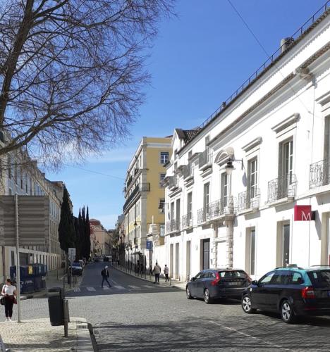 a street with buildings and cars parked on the street at Central Lisbon Studio in Lisbon