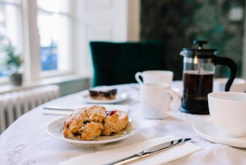 a table with two plates of food and cups of coffee at Ralph's in Moira