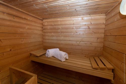 a wooden sauna with a white towel sitting in it at Domaine de La Gressière in La Bernerie-en-Retz