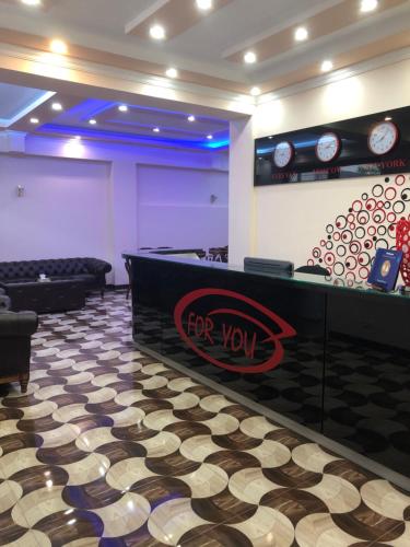 a waiting room with a for you counter and chairs at Hotel For You in Yerevan