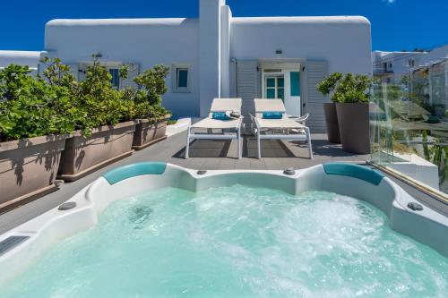 a hot tub on the balcony of a house at Semeli Hotel Mykonos in Mýkonos City